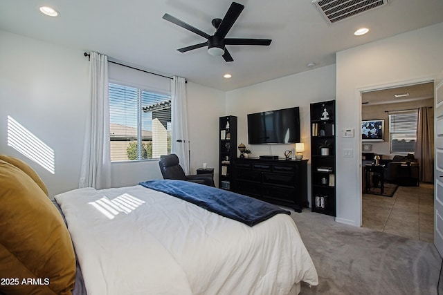 bedroom with light carpet, a ceiling fan, visible vents, and recessed lighting