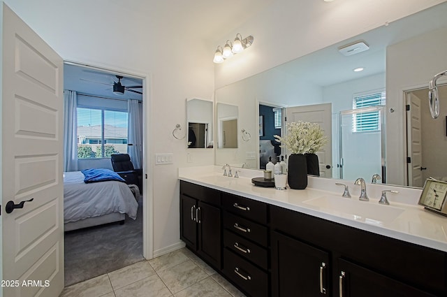 bathroom with ensuite bathroom, a sink, and tile patterned floors