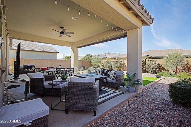 view of patio with a ceiling fan, an outdoor living space with a fire pit, a fenced backyard, grilling area, and outdoor dining area