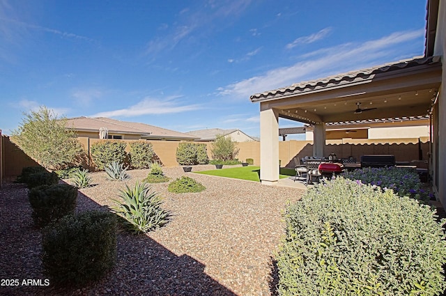 view of yard with a patio area, ceiling fan, and a fenced backyard