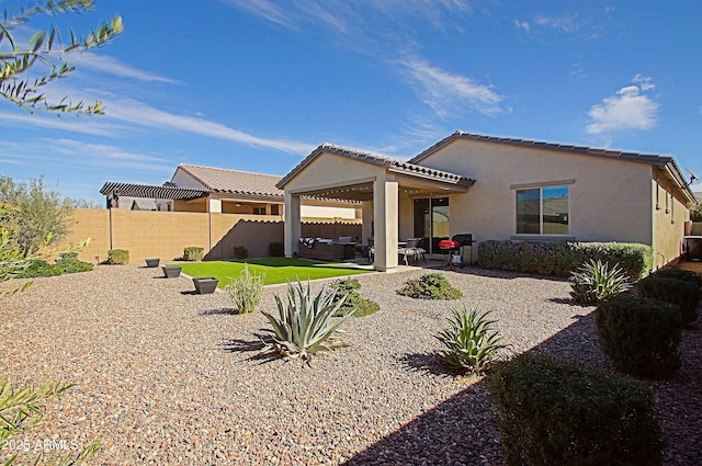 back of property featuring a patio area, outdoor lounge area, a fenced backyard, and stucco siding