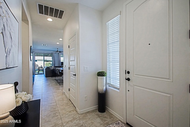 entryway with light tile patterned floors, ceiling fan, recessed lighting, visible vents, and baseboards