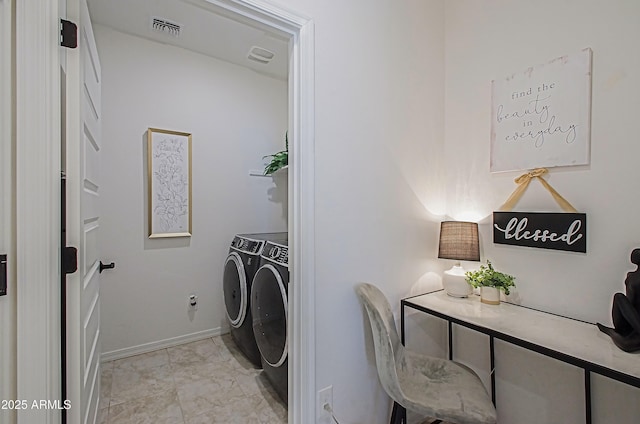 clothes washing area with washer and dryer, laundry area, visible vents, and baseboards