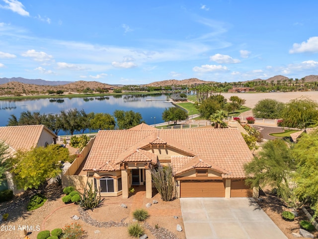 exterior space with a water and mountain view