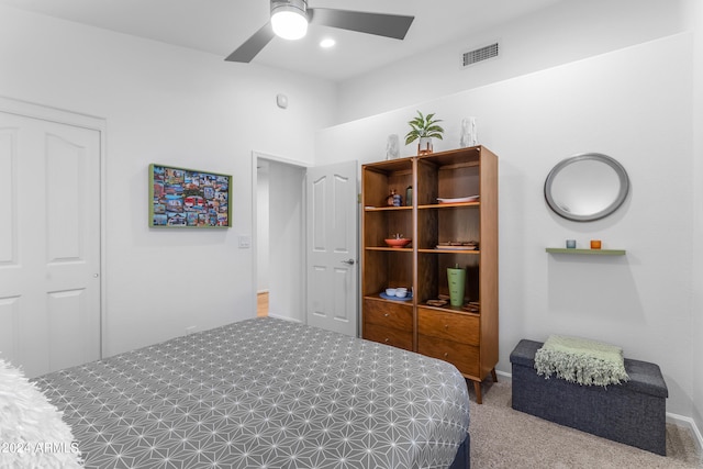 bedroom featuring a closet, ceiling fan, and light carpet