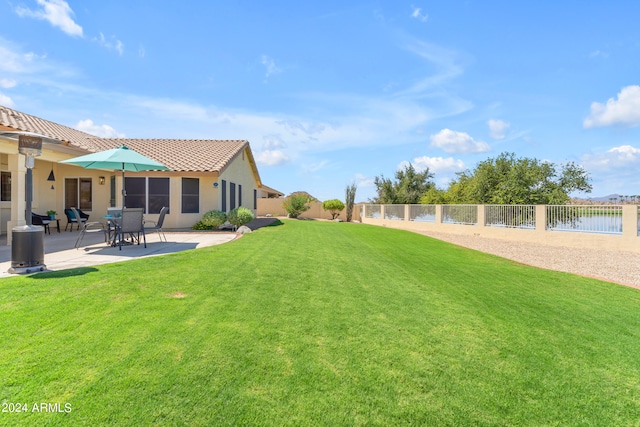 view of yard with a patio area and a water view