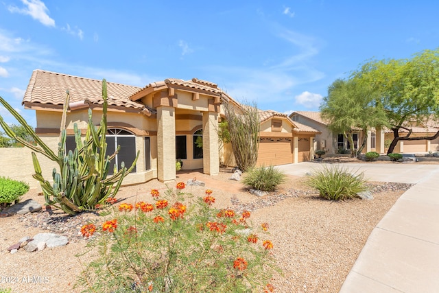 mediterranean / spanish-style home with a garage