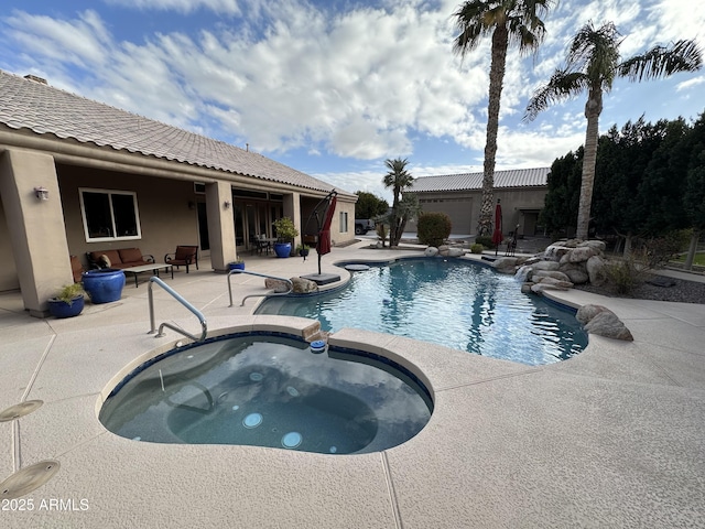 view of pool featuring a patio and an in ground hot tub