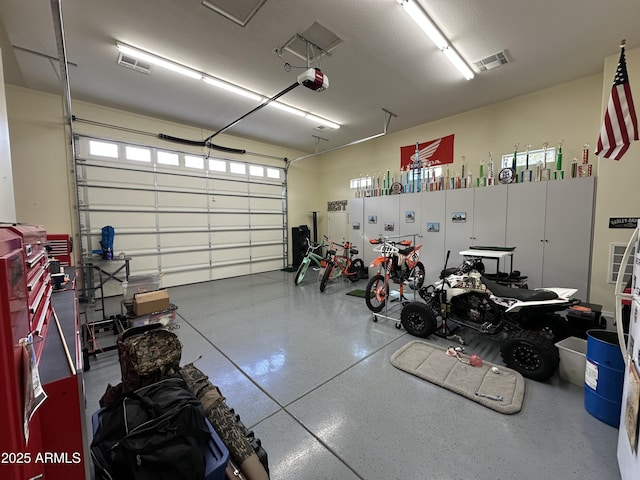 garage with visible vents and a garage door opener