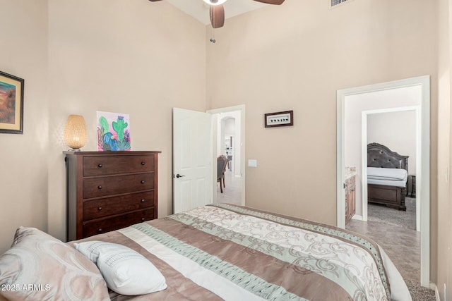 bedroom featuring a towering ceiling and a ceiling fan