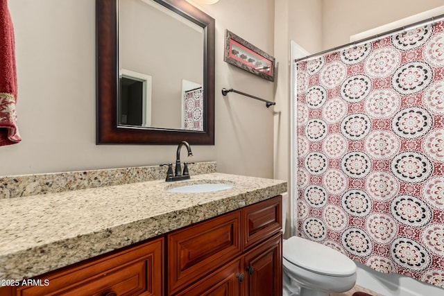 full bathroom featuring toilet, vanity, and a shower with curtain