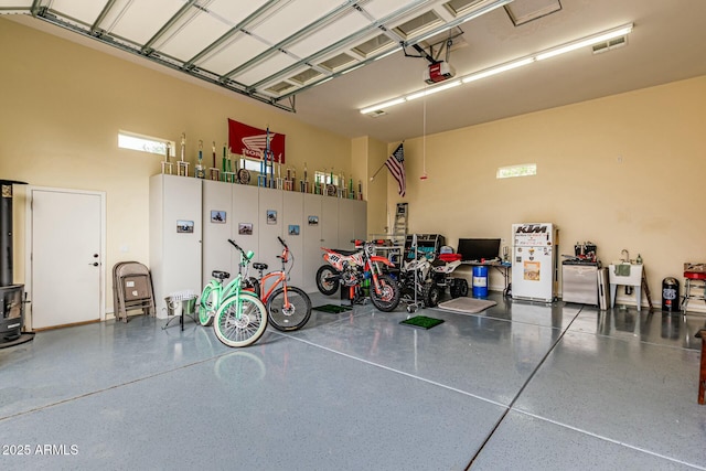 garage with visible vents and a garage door opener