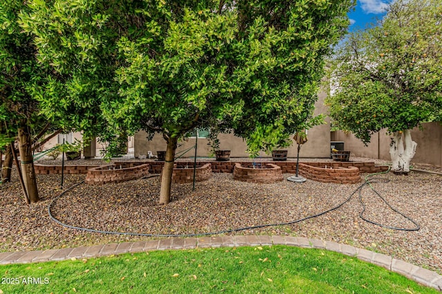 view of yard featuring an outdoor fire pit and fence