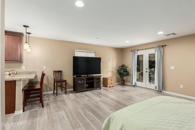 bedroom featuring visible vents, baseboards, light wood-style flooring, access to outside, and french doors