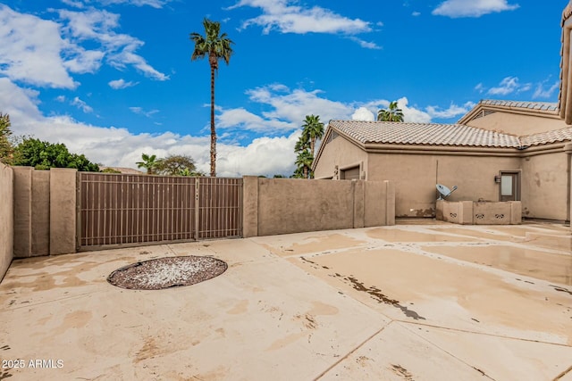 view of patio / terrace featuring fence and a gate