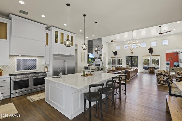 kitchen with light countertops, high quality appliances, and a ceiling fan