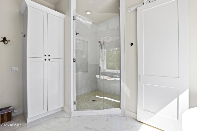 full bath with marble finish floor, a shower stall, and baseboards