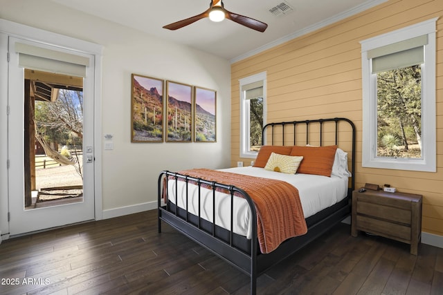 bedroom featuring access to outside, dark wood-style flooring, visible vents, and crown molding