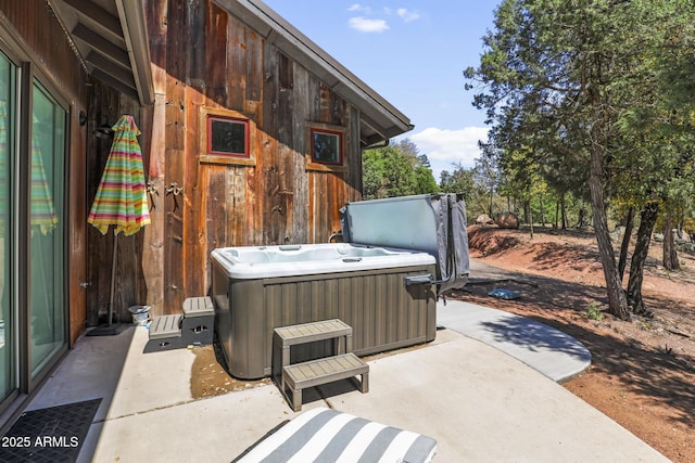 view of patio featuring central AC and a hot tub