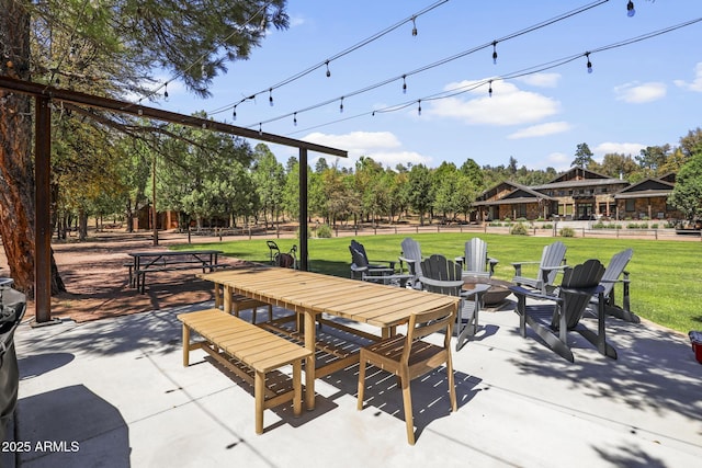 surrounding community featuring outdoor dining space, a patio, an outdoor fire pit, and a lawn