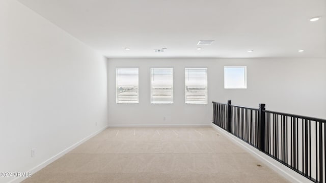 7384 W Buckhorn Trl, Peoria, AZ 85383 - unfurnished room featuring light carpet, baseboards, and recessed lighting