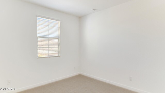 7384 W Buckhorn Trl, Peoria, AZ 85383 - empty room featuring light carpet and baseboards