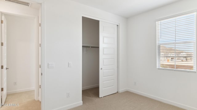 7384 W Buckhorn Trl, Peoria, AZ 85383 - unfurnished bedroom with light carpet, a closet, and baseboards