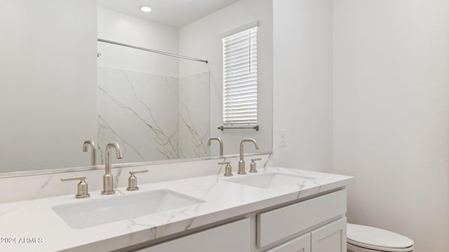 7384 W Buckhorn Trl, Peoria, AZ 85383 - full bathroom with toilet, double vanity, and a marble finish shower