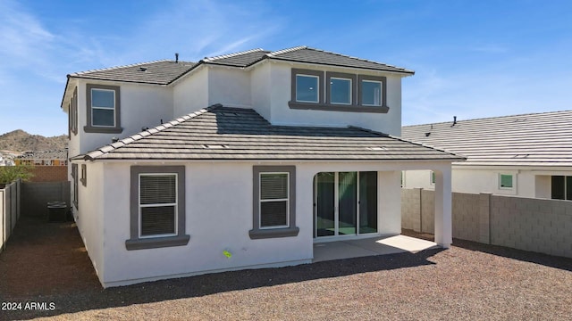 7384 W Buckhorn Trl, Peoria, AZ 85383 - back of house with a fenced backyard, stucco siding, a tiled roof, and a patio