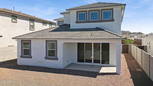 7384 W Buckhorn Trl, Peoria, AZ 85383 - rear view of house featuring a fenced backyard, a patio area, stucco siding, and a tiled roof
