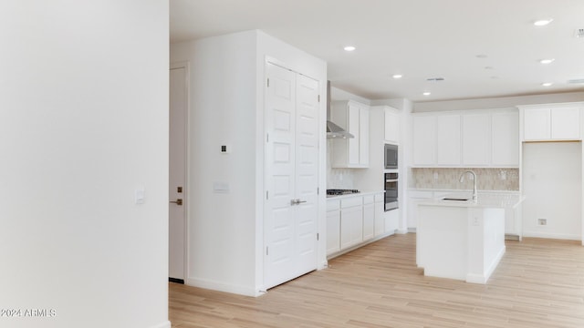 7384 W Buckhorn Trl, Peoria, AZ 85383 - kitchen with tasteful backsplash, light wood-style floors, stainless steel appliances, white cabinetry, and recessed lighting