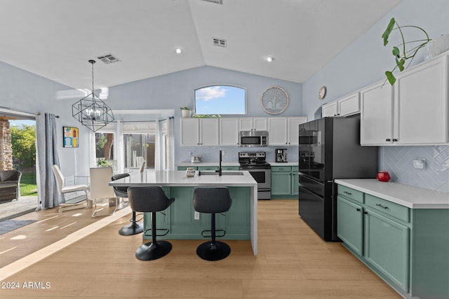 15912 W Central St, Surprise, AZ 85374 - kitchen with stainless steel appliances, green cabinetry, light countertops, a sink, and white cabinetry