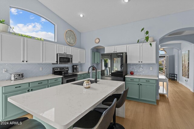 15912 W Central St, Surprise, AZ 85374 - kitchen with green cabinetry, stainless steel appliances, arched walkways, a sink, and recessed lighting