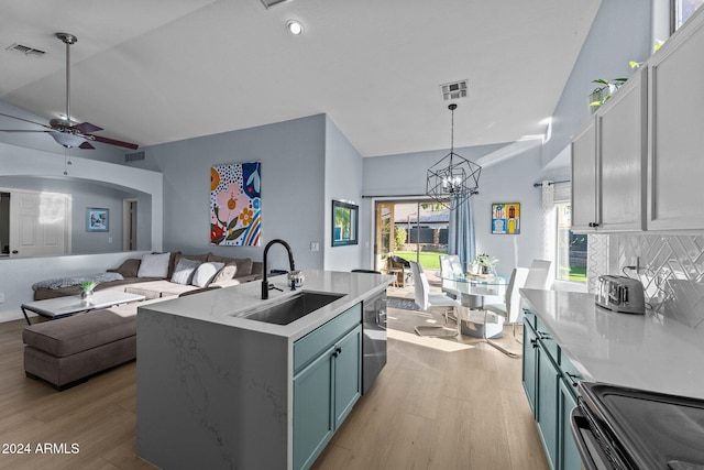 15912 W Central St, Surprise, AZ 85374 - kitchen featuring a sink, light wood-style floors, open floor plan, stainless steel dishwasher, and a chandelier