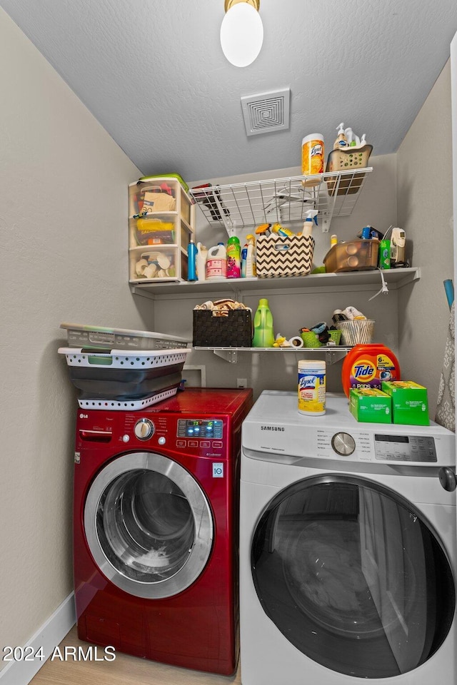 15912 W Central St, Surprise, AZ 85374 - laundry room featuring washer and clothes dryer, baseboards, and a textured ceiling