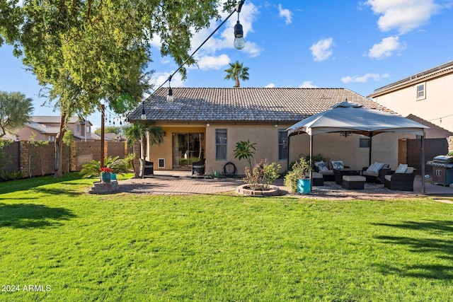 15912 W Central St, Surprise, AZ 85374 - back of house with an outdoor living space with a fire pit, a gazebo, a patio area, a tiled roof, and stucco siding