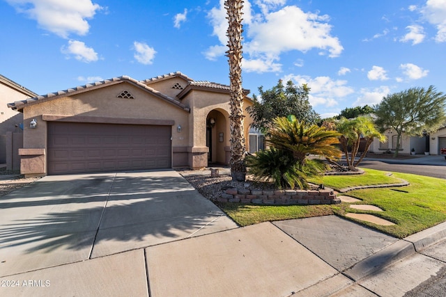15912 W Central St, Surprise, AZ 85374 - mediterranean / spanish-style home with stucco siding, concrete driveway, a garage, a tiled roof, and a front lawn