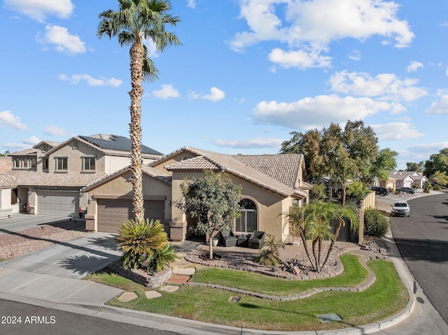 15912 W Central St, Surprise, AZ 85374 - view of front of property featuring driveway, stucco siding, a tiled roof, a residential view, and an outdoor hangout area