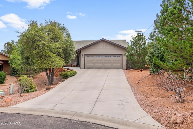 view of front facade with a garage, concrete driveway, a shingled roof, and board and batten siding