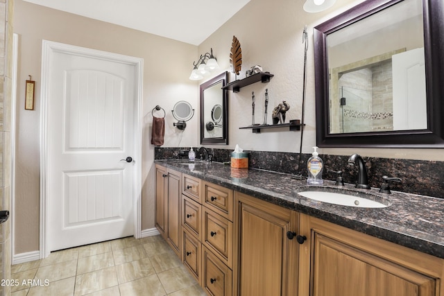 full bath with a tile shower, double vanity, tile patterned flooring, and a sink