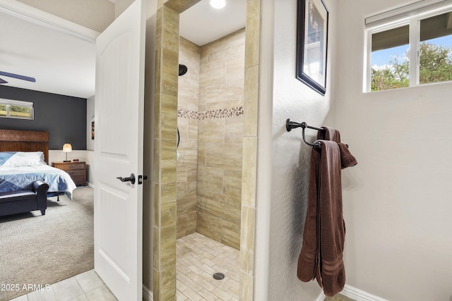 full bath featuring a ceiling fan, baseboards, a tile shower, tile patterned floors, and ensuite bath