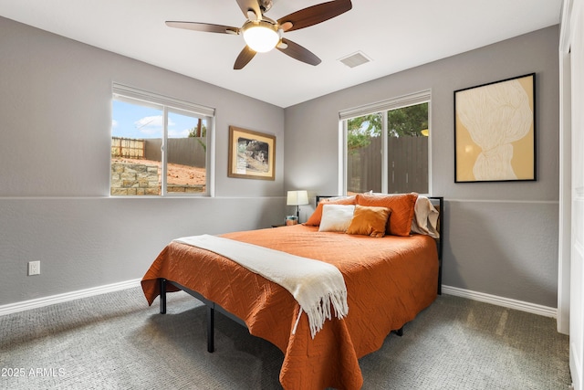 bedroom with visible vents, multiple windows, and baseboards