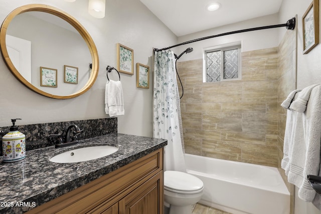 bathroom featuring toilet, shower / tub combo, and vanity