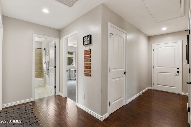 corridor with recessed lighting, dark wood-style flooring, visible vents, and baseboards