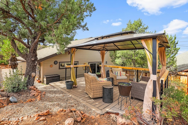 deck with a gazebo, fence, and an outdoor living space