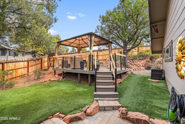 view of yard featuring a fenced backyard, a wooden deck, and a gazebo