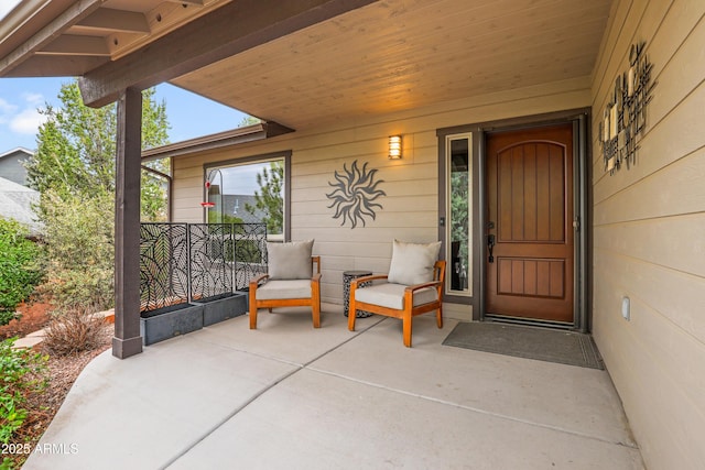 view of exterior entry featuring covered porch