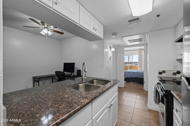 12123 W Bell Rd Unit 211, Surprise, AZ 85378 - kitchen featuring electric stove, light tile patterned flooring, white cabinetry, ceiling fan, and dark stone countertops