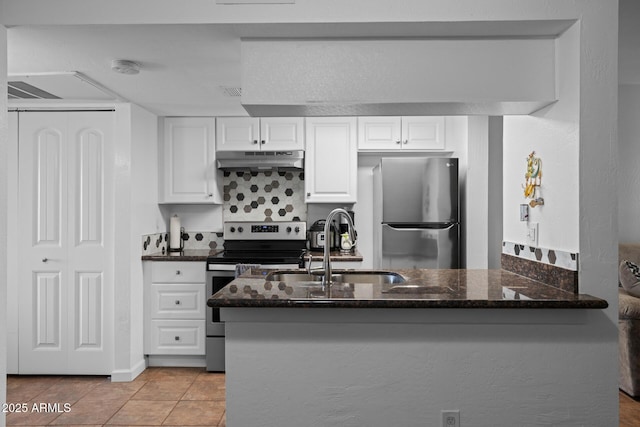 12123 W Bell Rd Unit 211, Surprise, AZ 85378 - kitchen featuring appliances with stainless steel finishes, under cabinet range hood, dark stone counters, white cabinets, and light tile patterned flooring