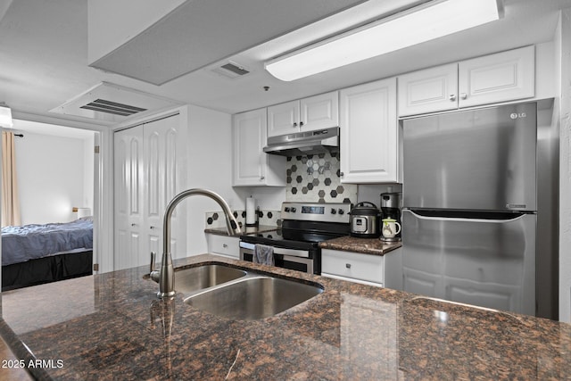 12123 W Bell Rd Unit 211, Surprise, AZ 85378 - kitchen featuring appliances with stainless steel finishes, under cabinet range hood, white cabinets, and dark stone countertops